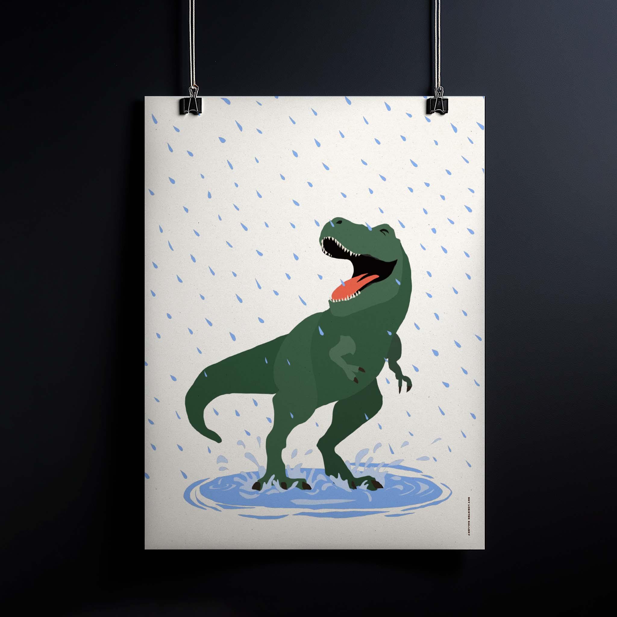"Puddles" – Fun and playful graphic poster for kids featuring a happy T-Rex splashing in a puddle in the rain. Vibrant and joyful design, perfect for nurseries, playrooms, and kids' bedrooms, celebrating dinosaurs, laughter, and carefree childhood adventures. Poster hanging.